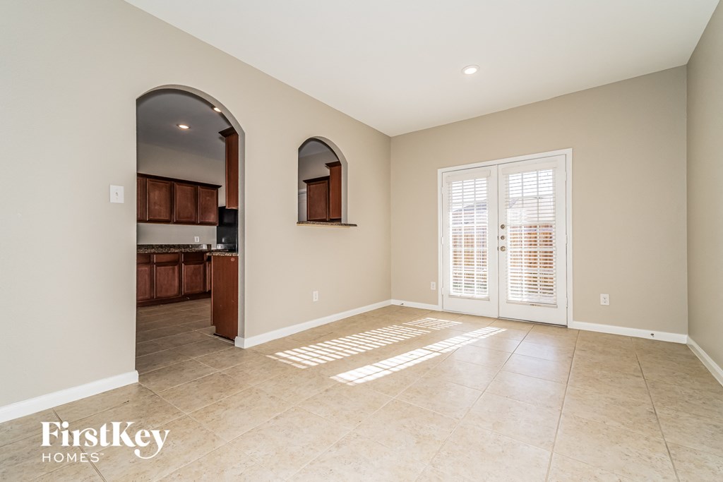 the living room is open to the kitchen and dining room