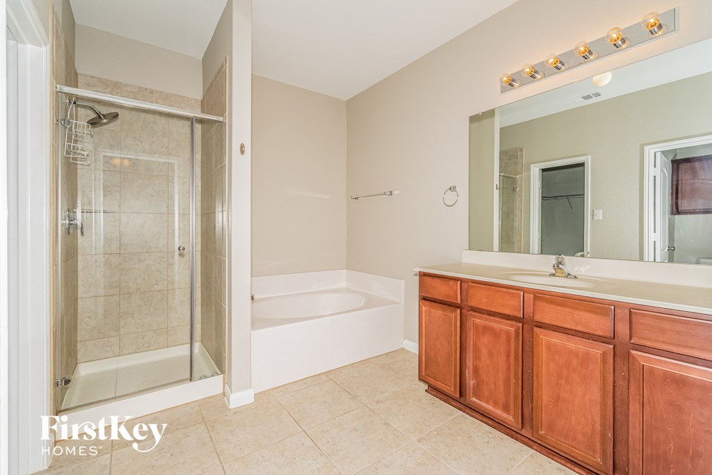 a bathroom with a shower and a sink and a mirror