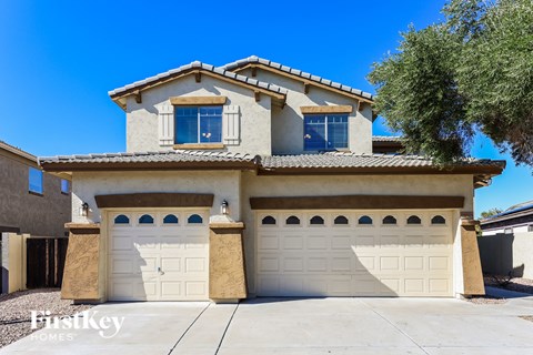 a house with two garage doors in front of it