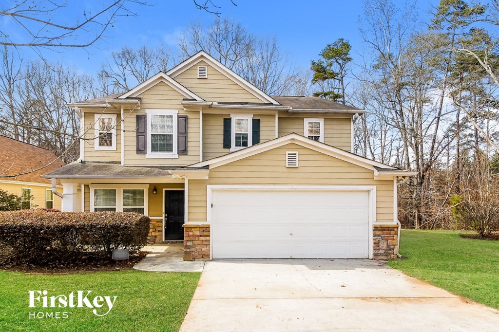 a yellow house with a white garage door