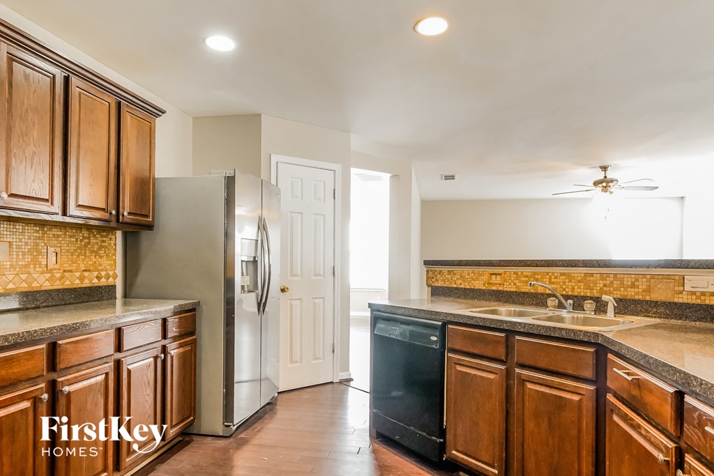 a kitchen with wooden cabinets and stainless steel appliances