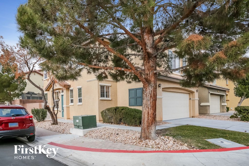 a yellow house with a tree in front of it