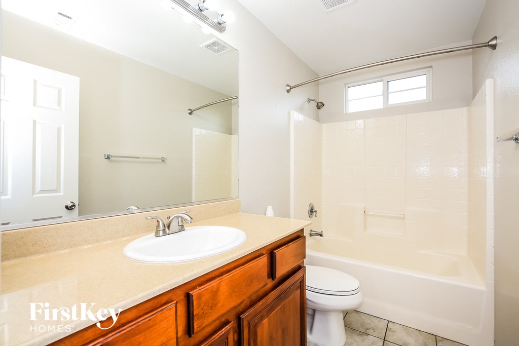 a bathroom with a sink and a toilet and a tub