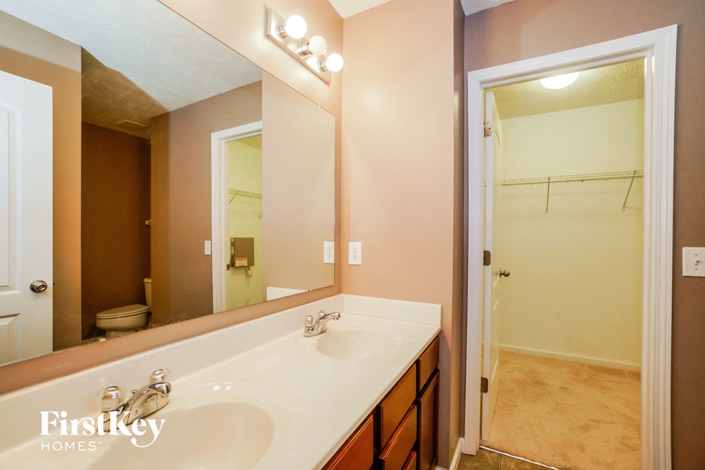 a bathroom with a large mirror and a white sink