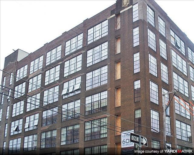 a tall brick building with a lot of windows