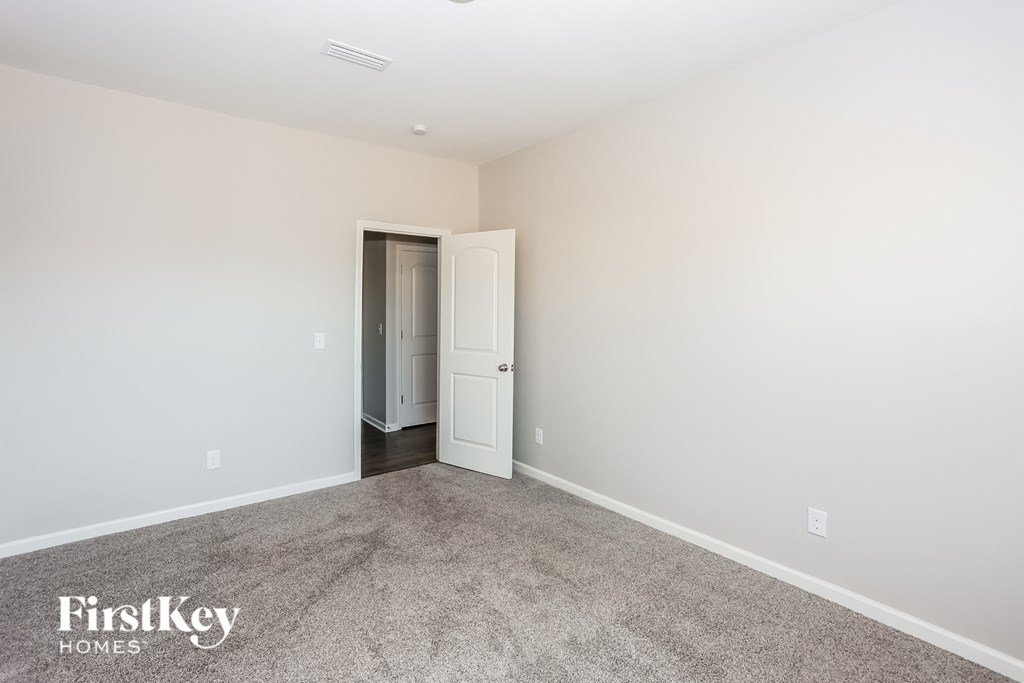 a bedroom with a carpeted floor and white walls