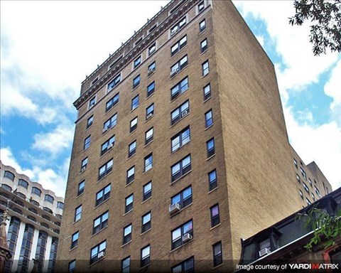 a tall brown building with many windows on it