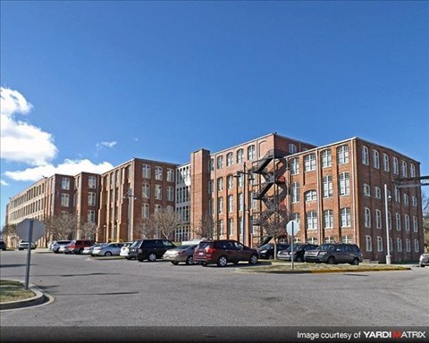 a large building with cars parked in front of it