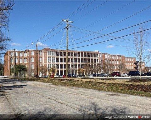 a large brick building on the side of a street
