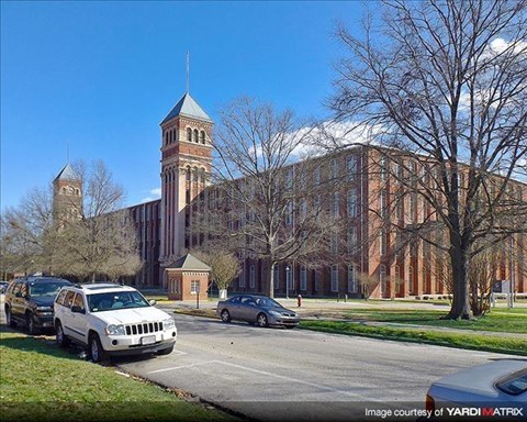 a large building with a clock tower on a street