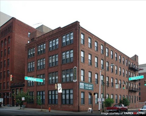 a large brick building on the corner of a street