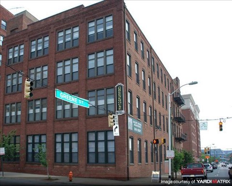a large brick building on the corner of a street