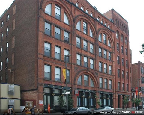 a large brick building on the side of a street