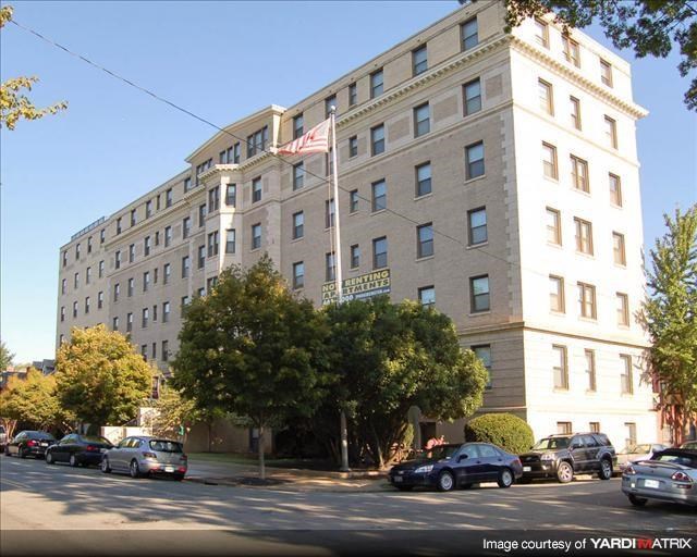 a large building with cars parked in front of it