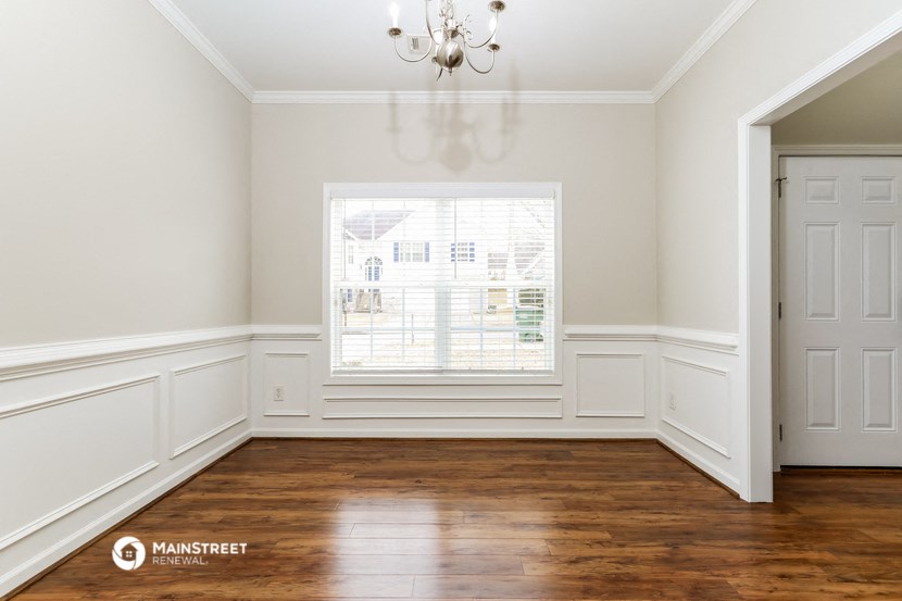 an empty room with white walls and a window