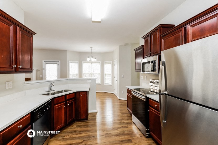 a kitchen with wooden cabinets and stainless steel appliances