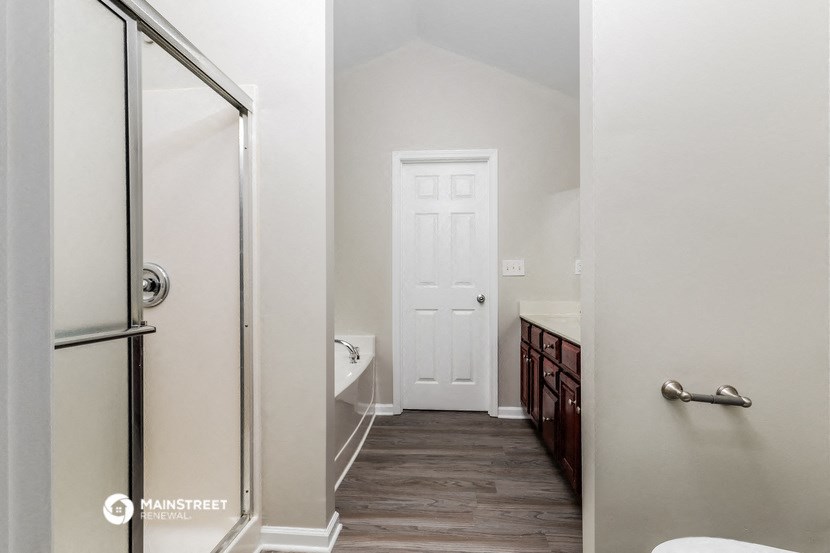 a bathroom with a walk in shower and a toilet