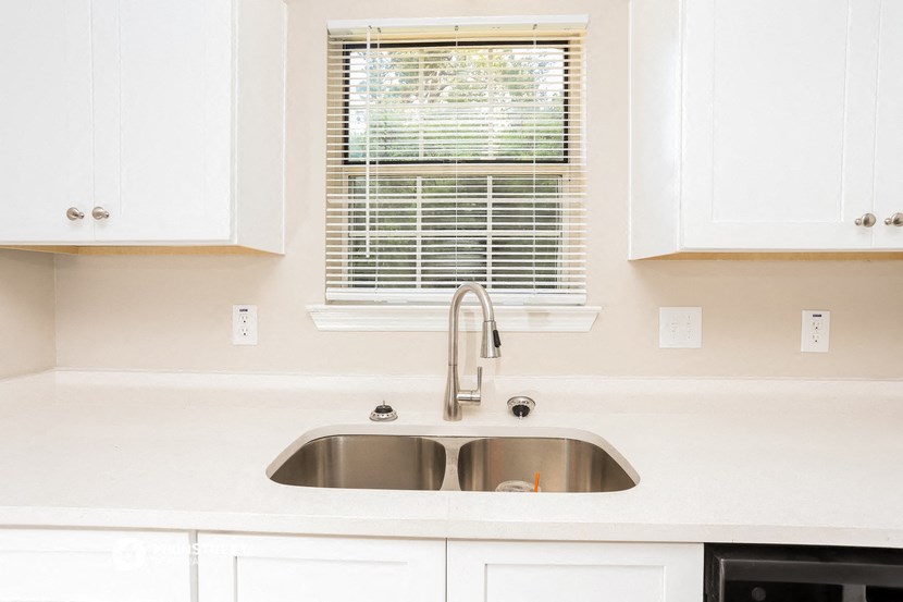 a kitchen with a sink and a window