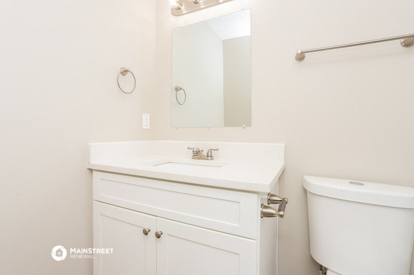 a bathroom with a sink and a mirror and a toilet