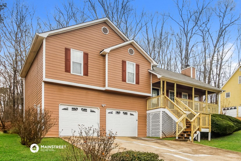 the front of a house with a garage and a deck