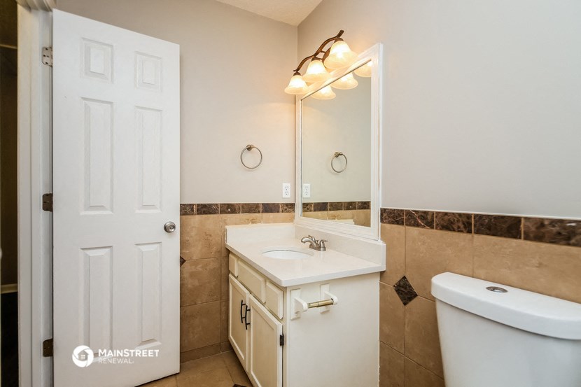 a bathroom with a sink and a mirror and a toilet