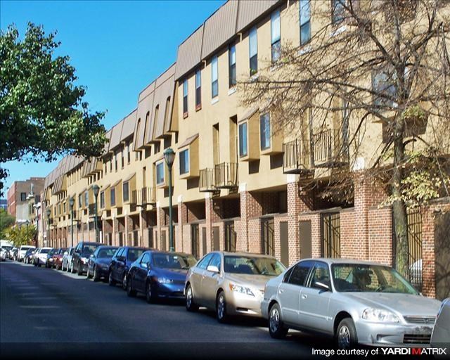 a row of cars parked on the side of a street