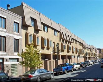 a row of buildings with cars parked in front of them
