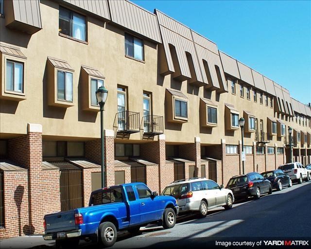 a blue truck parked in front of a building