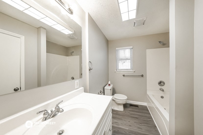 a bathroom with a sink and a mirror and a toilet