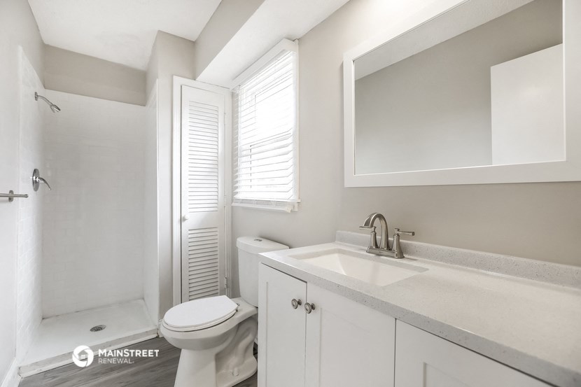 a bathroom with a sink and a toilet and a shower