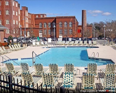 a large swimming pool with chairs around it