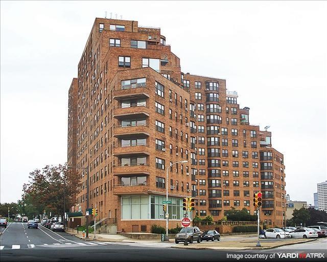 a tall brick building on the corner of a city street