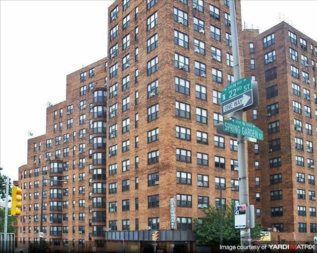 a tall building with a street sign in front of it