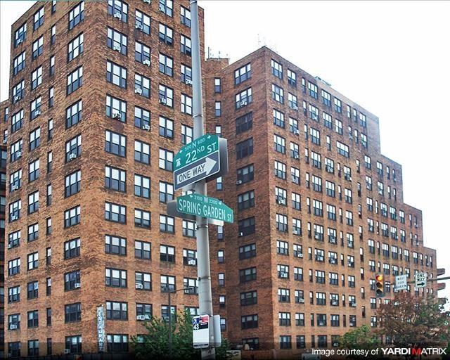 a tall building with street signs in front of it