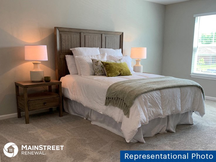 a bedroom with a bed and two lamps