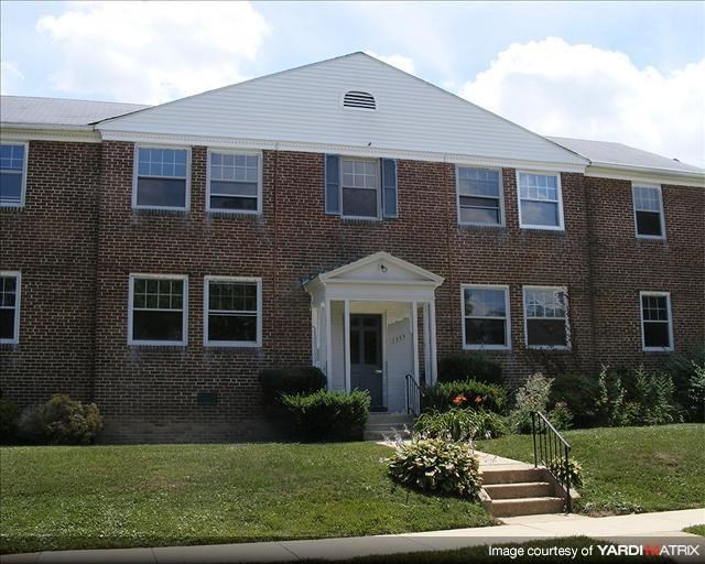 a brick building with a lawn in front of it