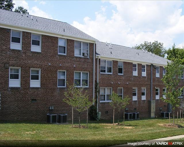 a brick building with trees in front of it