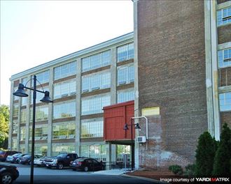 a large building with a red door in front of it