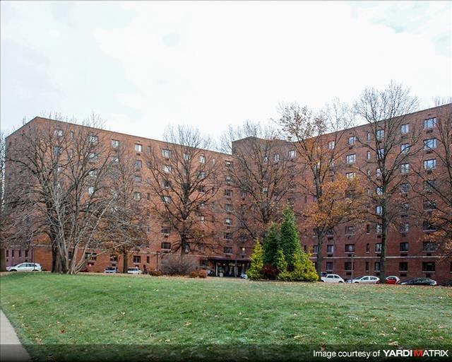 a large brick building with trees in front of it