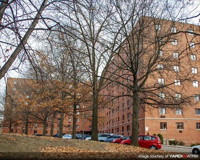 a large brick building with cars parked in front of it