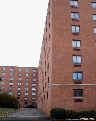 a tall brick building with many windows on it