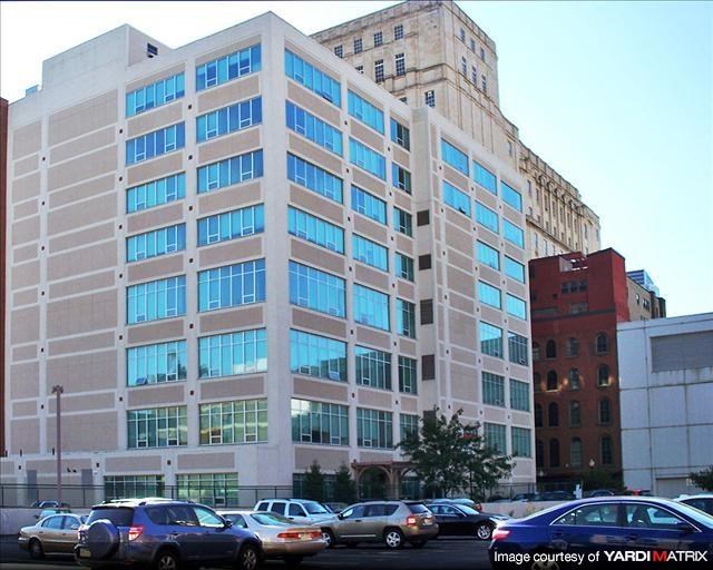 a large building with cars parked in front of it