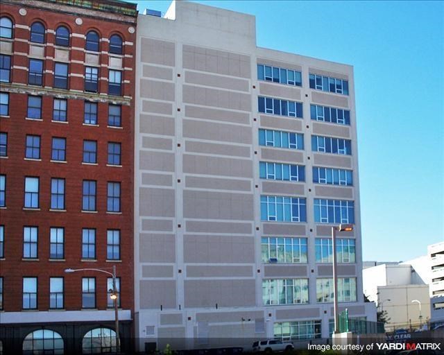a tall building with many windows in front of it