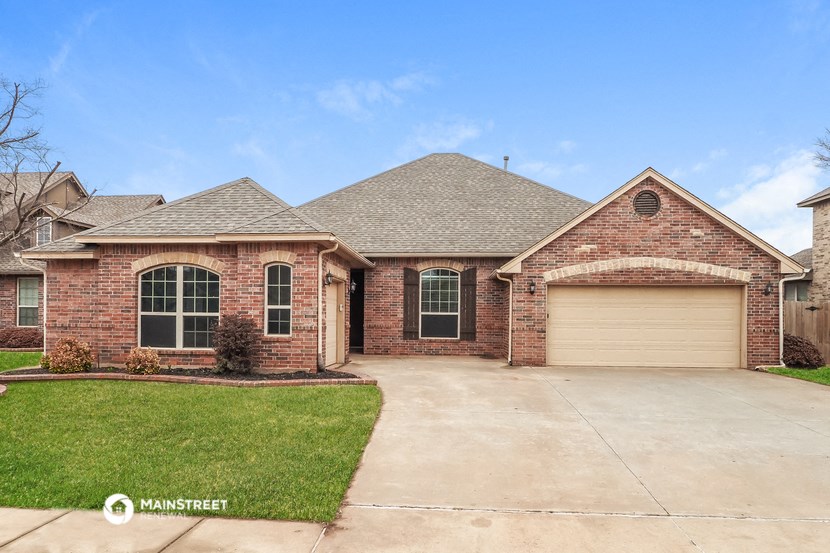 a brick house with a garage and a driveway