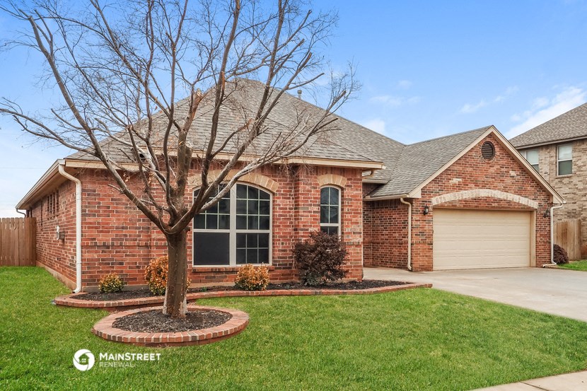 a brick house with a tree in front of it