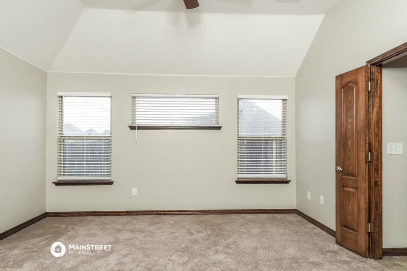 the living room is spacious and clean with three windows