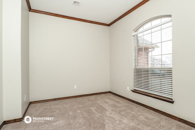 the living room is spacious and has a large window