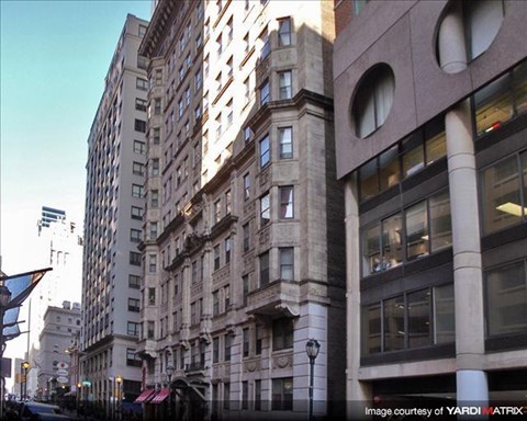 a tall building on the corner of a city street