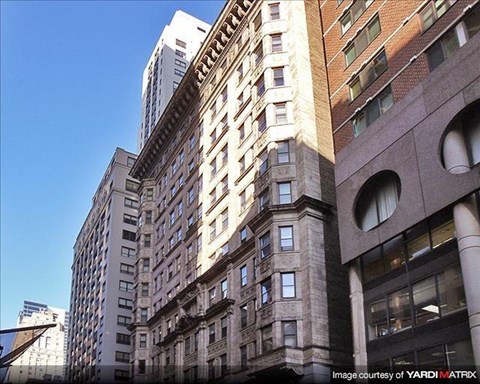 a tall building in a city with other tall buildings