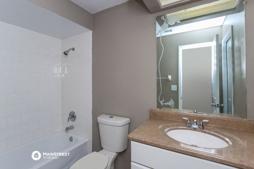 a bathroom with a sink and a toilet and a bath tub